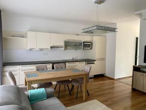 a kitchen with a table and chairs in a room at Mark Apartman in Balatonszárszó