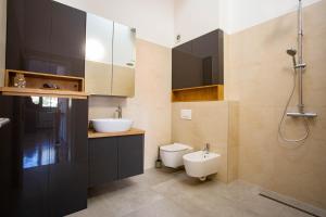 a bathroom with a toilet and a sink and a shower at Exclusive Penthouse Old town with sauna and jacuzzi in Mostar