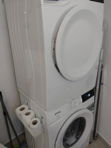 a washing machine with a mirror on top of it at Studio Apartment Klokke in Supetar