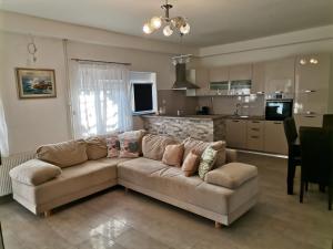 a living room with a couch and a kitchen at Apartmani Sidro Senj in Senj