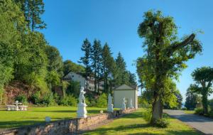 a park with statues and a building in the distance at Vintage Hotel Petrisberg in Trier
