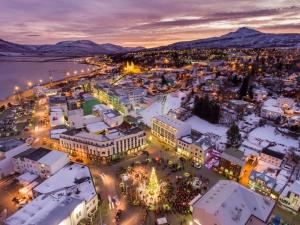an aerial view of a town in the snow at night at H3 apartment - cozy downtown apartment in Akureyri