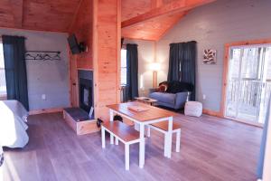 a living room with a table and a couch at Avenwood Cabins in Logan