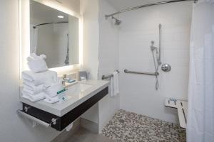 a bathroom with a sink and a mirror and towels at Holiday Inn Express - Sunnyvale - Silicon Valley, an IHG Hotel in Sunnyvale