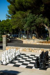 a chess board on a sidewalk in a park at Waterman Beach Village in Supetar