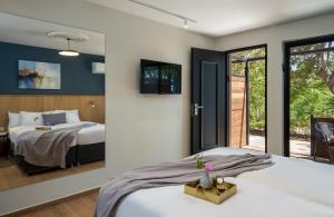 a bedroom with a bed and a large window at Keshet Yehonatan Country Lodging in Keshet