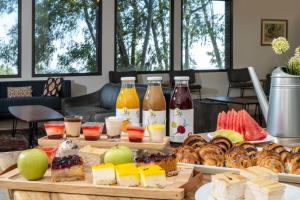 a table topped with different types of pastries and drinks at Keshet Yehonatan Country Lodging in Keshet