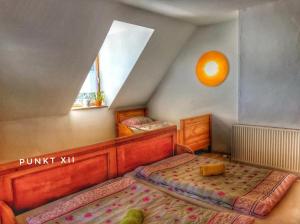 a attic bedroom with two beds and a window at Wohnung 1 in Burghaslach