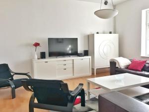 a living room with a couch and a tv at Haus Stothfang - Ferienwohnung 3 in Sassnitz