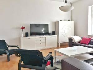 een woonkamer met een bank en een tv bij Haus Stothfang - Ferienwohnung 3 in Sassnitz