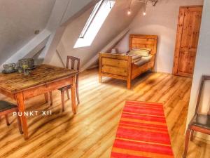 a attic room with a table and a bed at Wohnung 3 in Burghaslach