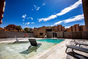 a swimming pool on the roof of a building at Vértice Indalo Almería in Almería