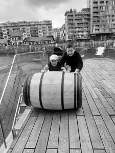 two children are sitting in a barrel on a boat at Hauseboat Prague in Prague