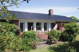 une maison en briques avec une terrasse couverte dans l'établissement Villa Hassel, à Middelfart