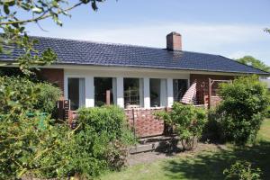 a home with a brick house with a porch at Villa Hassel in Middelfart