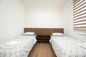 Postel nebo postele na pokoji v ubytování Zanes Apartment