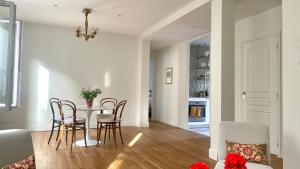 a dining room and living room with a table and chairs at Petit Vert Epernay in Épernay