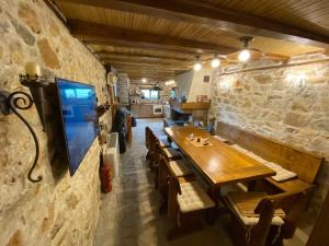 a dining room with a wooden table and chairs at Villa Ahrida in Smolyan