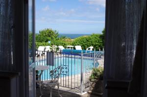 a view of a swimming pool through a window at Eastmount Hall Hotel in Shanklin
