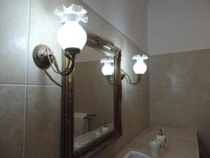 a bathroom with a mirror and a sink at Peters Mansion Bougainvillea Premesis in Mtwapa