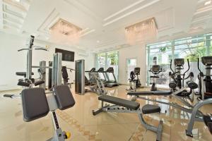 a gym with several treadmills and exercise bikes at ELEGANT 1 Bedroom in Orient Resort & Spa in Jomtien Beach