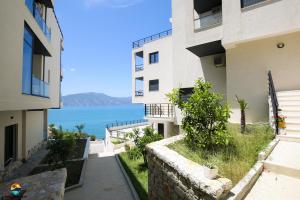 an apartment building with a view of the ocean at Sunny Hill Residence in Vlorë