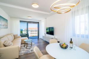a living room with a couch and a table at Apartments Zadro in Dubrovnik