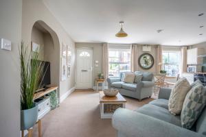 a living room with two couches and a tv at Southbank Cottage in York