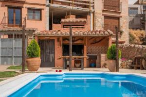 a large blue swimming pool in front of a building at Casa Fuster in San Agustín