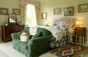 a bedroom with a bed and a green couch at Ballyduff House in Thomastown