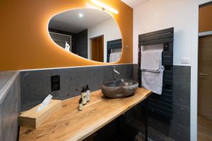 a bathroom with a sink and a mirror at Domaine du Bugassou, Chambres, Table d'hôtes & SPA in Belvès