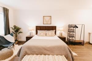 a bedroom with a bed and two lamps and a chair at 230 9th Avenue in Ouray