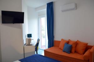 a living room with a couch and a window at Andrea Room&Breakfast in Capaccio-Paestum