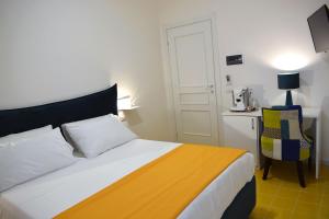 a bedroom with a bed and a table and a chair at Andrea Room&Breakfast in Capaccio-Paestum