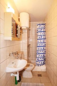 a small bathroom with a toilet and a sink at Apartments Ivana - free parking and 100m from the beach in Trpanj