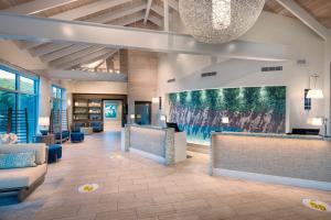a lobby with a large painting on the wall at Limetree Beach Resort by Club Wyndham in Raphune