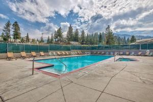 a swimming pool with chairs and a fence at LUXE 4 Blue Diamond Lake Tahoe Lodge in Stateline