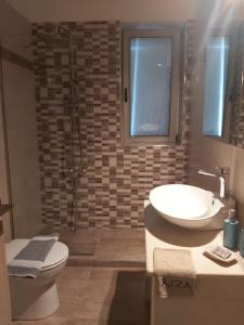 a bathroom with a sink and a toilet at Riza Apartments in Kardamyli +61 photos