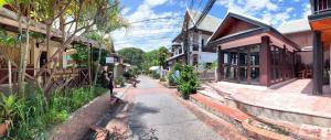 a street in an old town with buildings at Siridel Luang Prabang in Luang Prabang