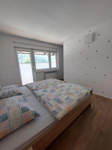 A bed or beds in a room at Apartments Marica