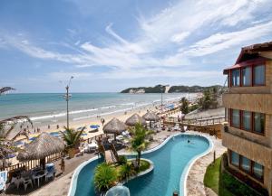 a resort with a swimming pool and a beach at Visual Praia Hotel in Natal