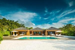 a house with a pool in front of it at COMO Parrot Cay in Sandy Point