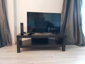 a flat screen tv sitting on a black entertainment center at Piso centrico amplio-luminoso in Zarautz