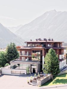 a rendering of a house with mountains in the background at ARX Guesthouse in Schladming