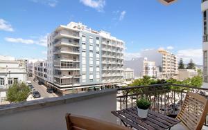a balcony with two benches and a building at Blue Ocean Rooftop in Olhão