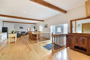 a living room with a kitchen and a dining room at 5 Bed Barn Conversion - with private hot tub in Birchington