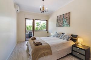 a bedroom with a large bed and a window at Brisa do Sul in Olhão