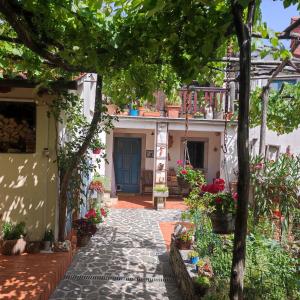 a courtyard of a house with a blue door at Apartma Hiša Pliska in Pliskovica