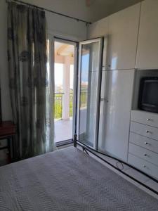 A bed or beds in a room at Derveni Summer House