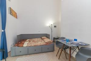 a bedroom with a bed and a table with chairs at Quercus Ilex B in Arzachena